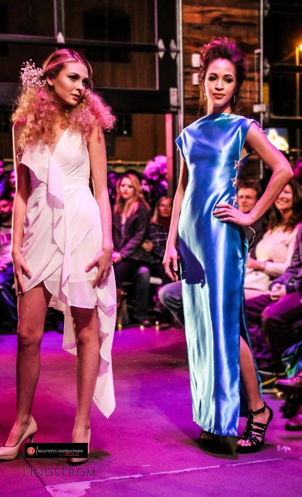Models on runway fashion show stage